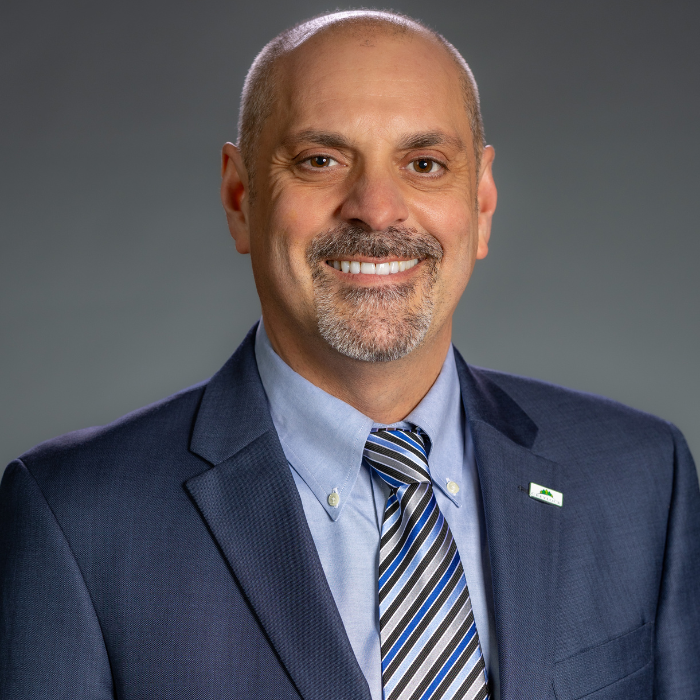 Charles Robertson wearing suit and tie